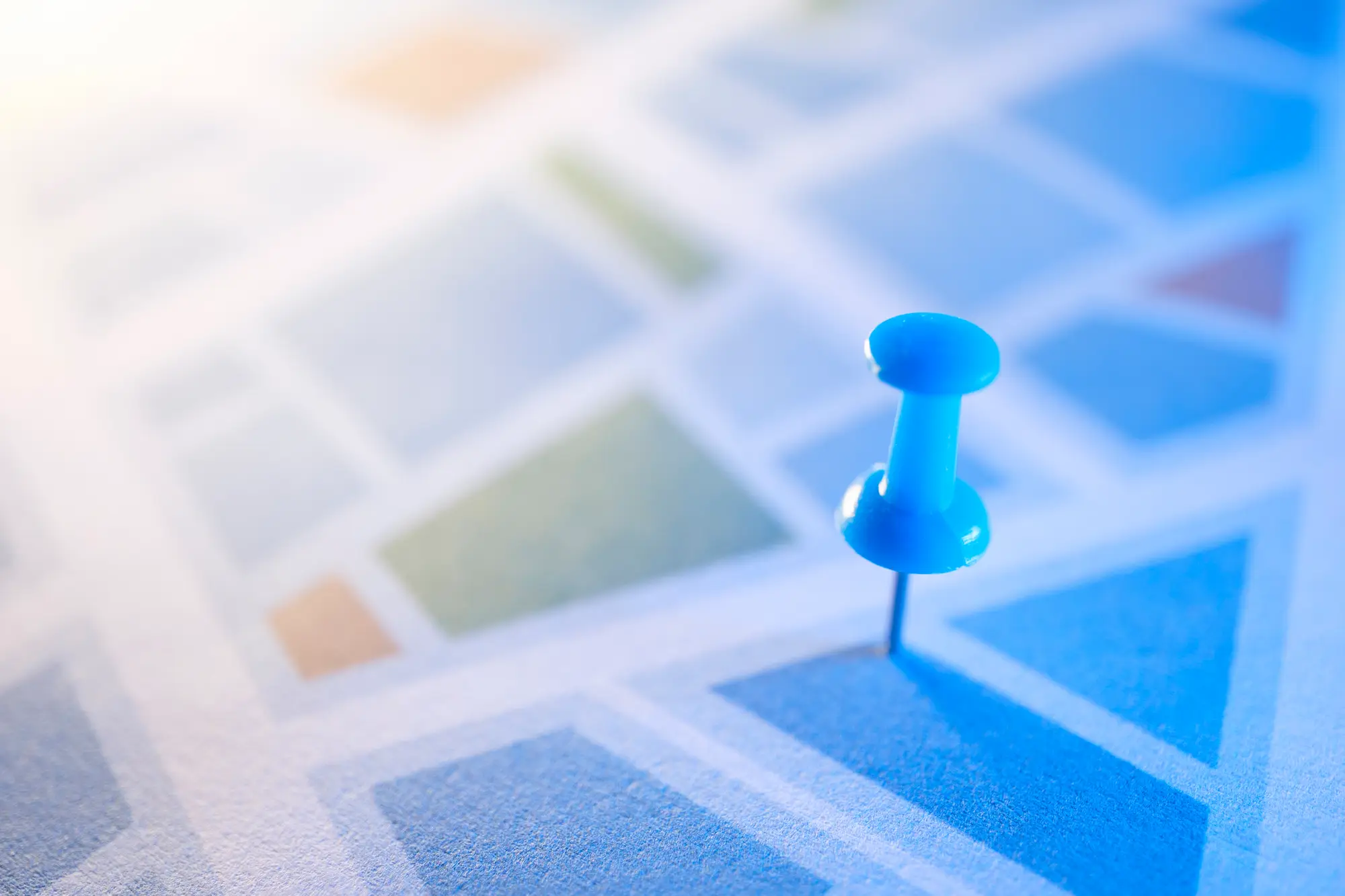 Blue push-pin marking a spot on a grid of color swatches